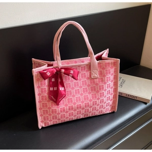 Detail of pink bridal tote with red Double Happiness pattern and decorative scarf handle