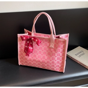Detail of pink canvas bridal tote featuring red Xi characters and luxury ribbon handle