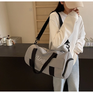 Close-up of lightweight grey gym bag with embroidery and adjustable shoulder strap
