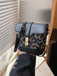 Vintage leopard print bucket bag with black leather patchwork and golden lock closure