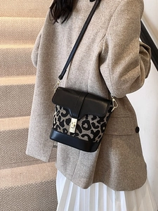 Stylish leopard print bucket bag with black leather trim and metal lock for women