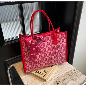 Detail of red wedding tote bag with traditional Double Happiness jacquard and ribbon