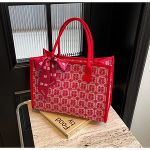 Detail of red woven canvas bridal tote bag with traditional Xi character and silk bow