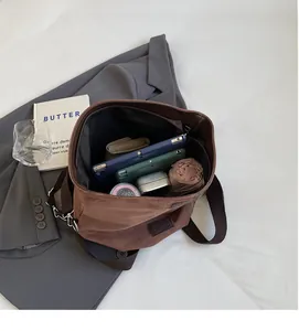 Spacious interior of brown faux suede tote bag showing tablet and daily essentials