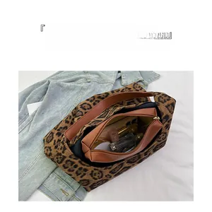 Detail view of leopard print tote bag interior with large capacity and inner pocket