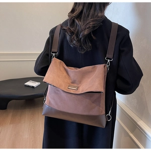 Rear view of model wearing the brown vintage canvas and leather backpack with wide strap
