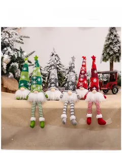 Close-up of sitting Christmas gnomes with knitted snowflake hats and star toppers