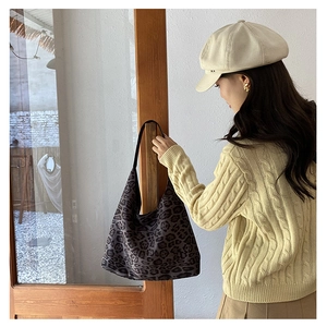 Detailed close-up of a large leopard print tote bag in soft fabric for casual daily use