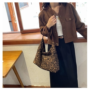 Detailed view of the large leopard print tote bag with premium leather handles and texture