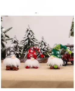 Three-piece knitted Christmas gnomes with snowflake patterns on snowy pine background