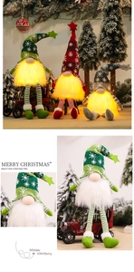 Close-up of glowing LED Christmas gnomes with knitted snowflake hats and warm light