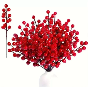 Artificial red Christmas berry stems in a white vase for festive holiday home decoration