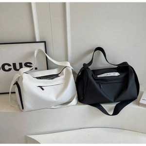 Detail of large capacity duffel bags in black and white with premium nylon fabric texture
