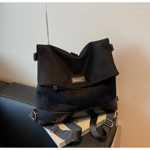 Detail of matte fabric and black synthetic leather with MOROMORO logo on the bag