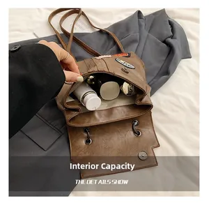 Brown vintage faux leather tote bag with retro patches showing large internal capacity
