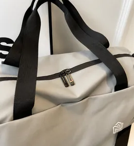 Detail shot of the smooth double zipper on a gray waterproof sports travel bag