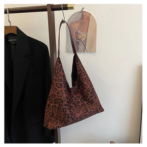 Detailed view of leopard print tote bag hanging with stylish long shoulder straps
