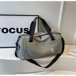 Detail view of the waterproof grey gym bag with durable straps and front zipper pocket