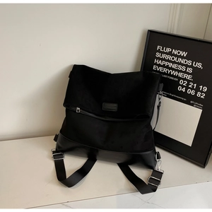 Detail of multi-functional black backpack with MUROMORO logo on premium textured fabric