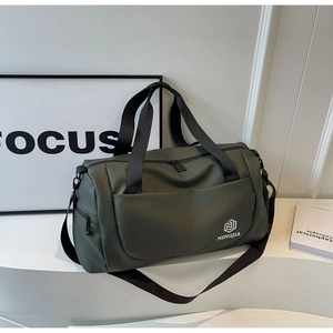 Detail view of dark green waterproof travel bag with double zipper and front pocket
