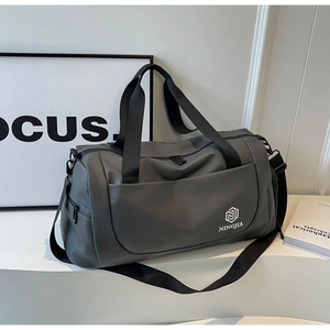 Detail view of large capacity grey travel bag with waterproof fabric and shoulder strap