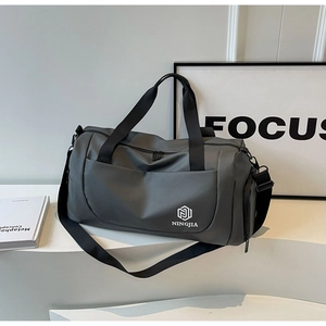 Detail of grey travel bag with NINGJIA logo and adjustable strap on modern display