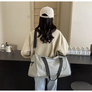 Light gray fitness bag with wet-dry separation shown in a modern cafe setting