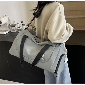 Grey large travel bag with separate shoe compartment and shoulder strap for gym and yoga