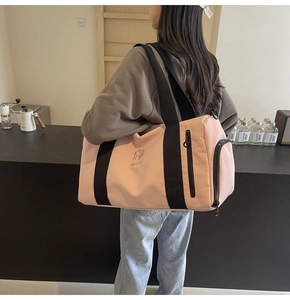 Borsa fitness rosa con cinghie nere e tasca con zip mostrata in ambiente interno
