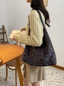 Leopard print tote bag for women shown with a model wearing a stylish beige sweater
