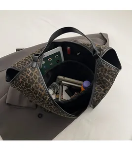 Top view showing the spacious interior of a leopard print tote bag with inner pockets
