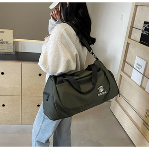 Model showing army green travel bag with dry wet separation and adjustable shoulder strap