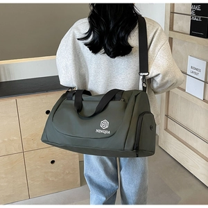 Detail of olive green travel bag showing waterproof fabric and separate shoe compartment