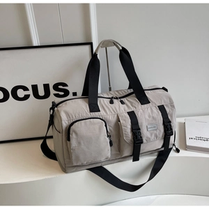 Détail du sac de voyage en nylon gris avec bandoulière noire et poche à boucle