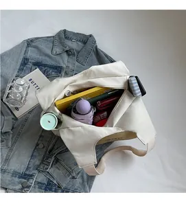 Top view of spacious white canvas tote bag interior filled with daily essentials
