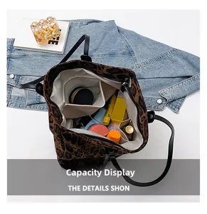 Interior view showing large capacity compartments and zipper pocket of leopard tote bag