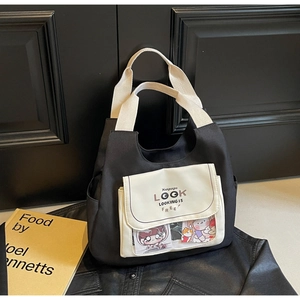 Close-up of black canvas tote bag with front pocket and clear PVC window design