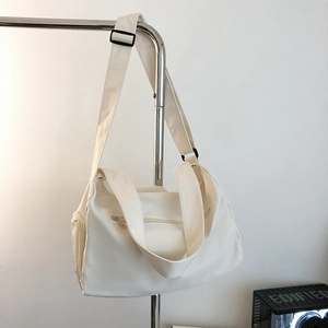 White canvas sports gym bag with adjustable strap and multiple zipper pockets