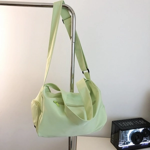 Detailed view of mint green yoga gym bag featuring multiple pockets and adjustable strap