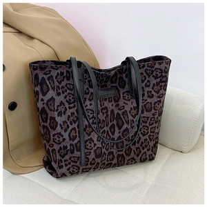 Close-up of the leopard print tote bag fabric and black branded square patch detail