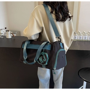 Détail du sac de voyage avec anses bleu canard et poche de séparation humide-sec