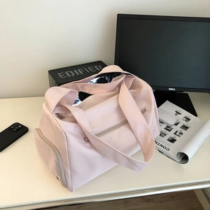 Detail view of pink waterproof yoga gym bag with large main compartment and side zipper