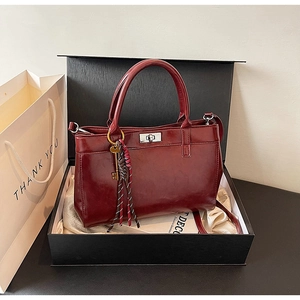 Détail d'un sac à main bordeaux en cuir PU avec fermoir rotatif en boîte cadeau