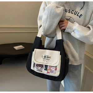 Detail of canvas tote bag with transparent window and cartoon character insert