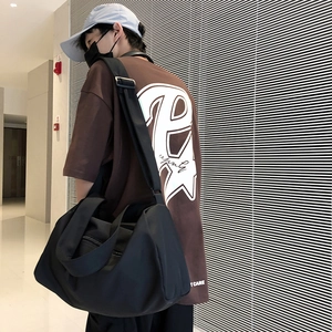 Detail of waterproof nylon sports gym bag featuring side zipper pocket and adjustable strap