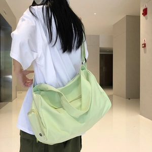 Detail view of mint green lightweight gym bag with adjustable shoulder strap and side zipper