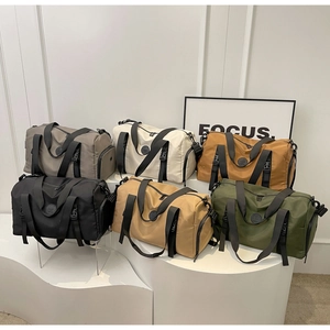 Multi-color travel duffel bags displayed on white pedestals for fitness and travel use