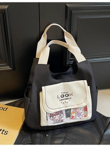 Large black canvas tote bag with transparent display window and cream woven handles