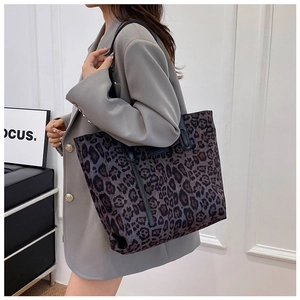 Fashionable leopard print tote bag styled with a grey blazer for modern urban look