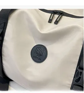 Detail of travel bag showing waterproof nylon texture and brand logo patch